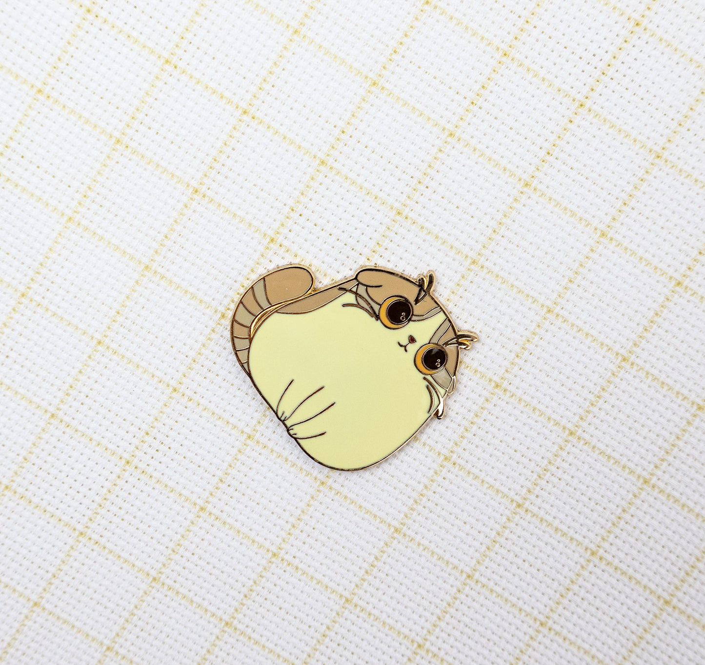 Magnetic Needle minder Cute cartoon cat pin on a grid background