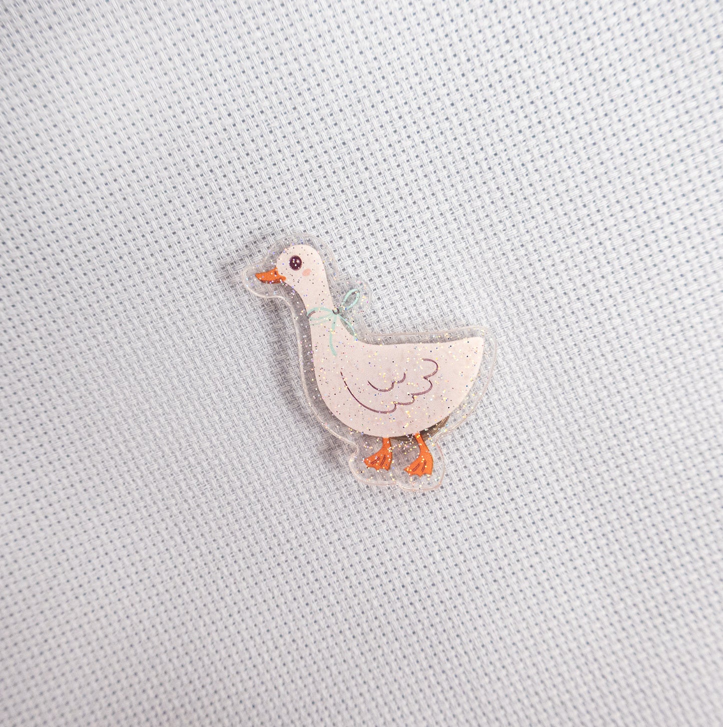 Small duck magnet on a textured light gray background