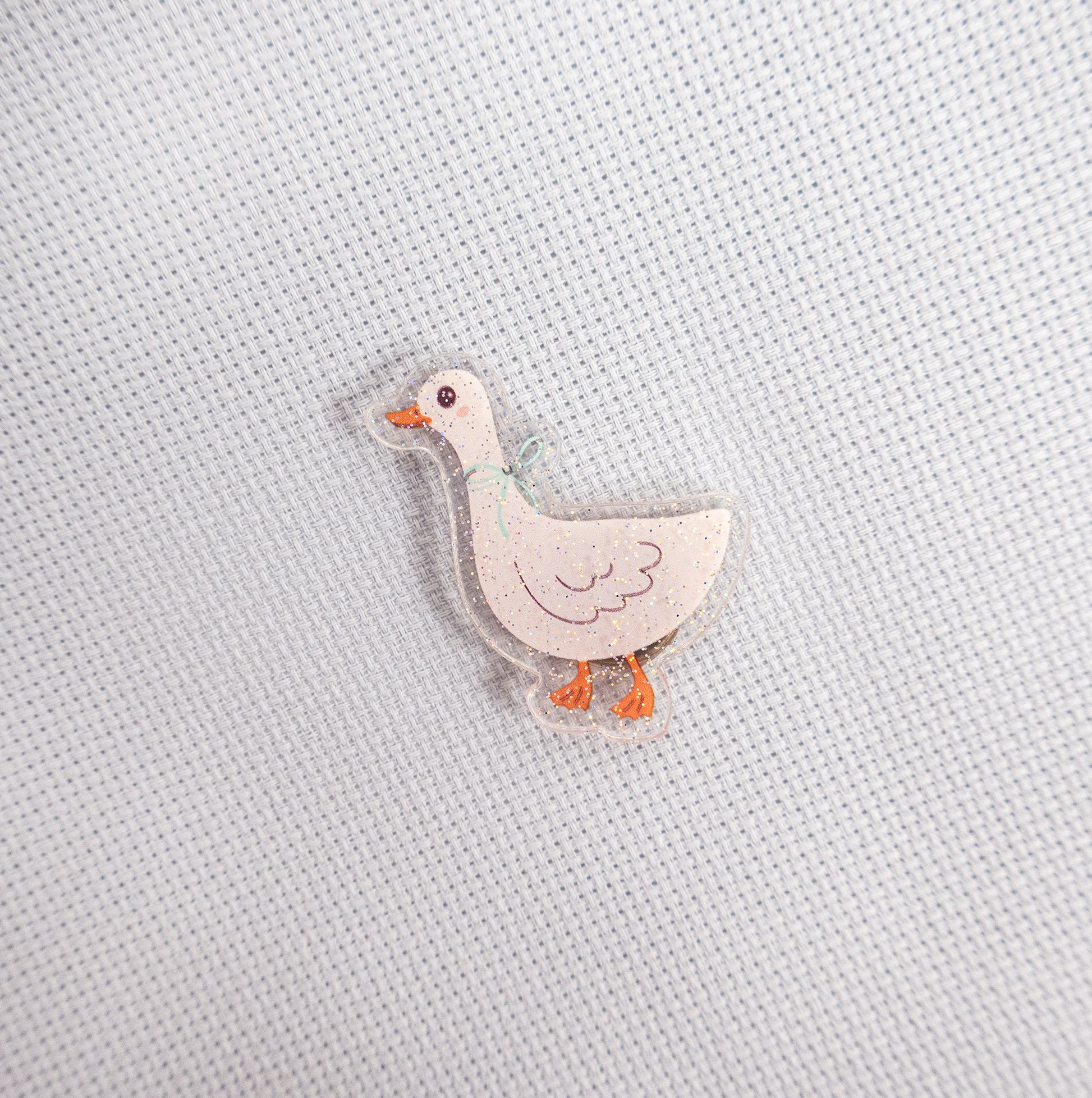 Small duck magnet on a textured light gray background