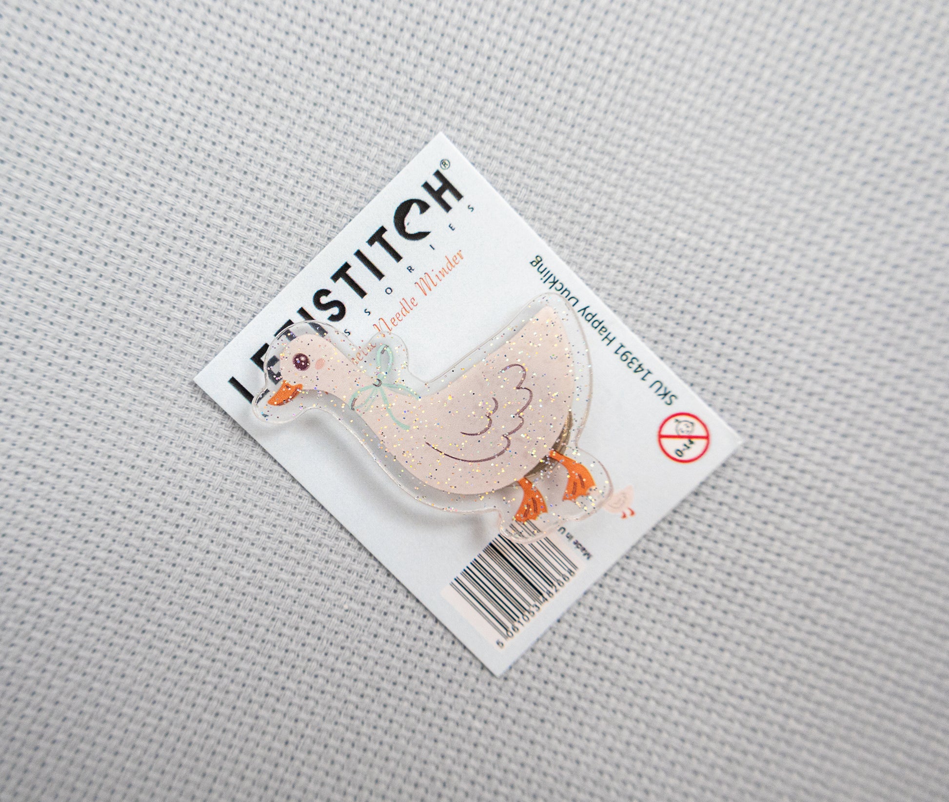 Product packaging with a duck design on a gray textured background