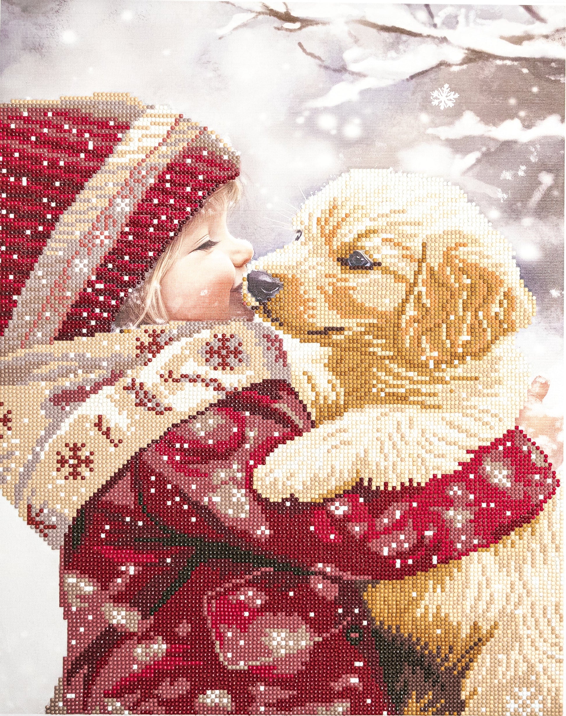 Child in winter clothing hugging a dog with a snowy background