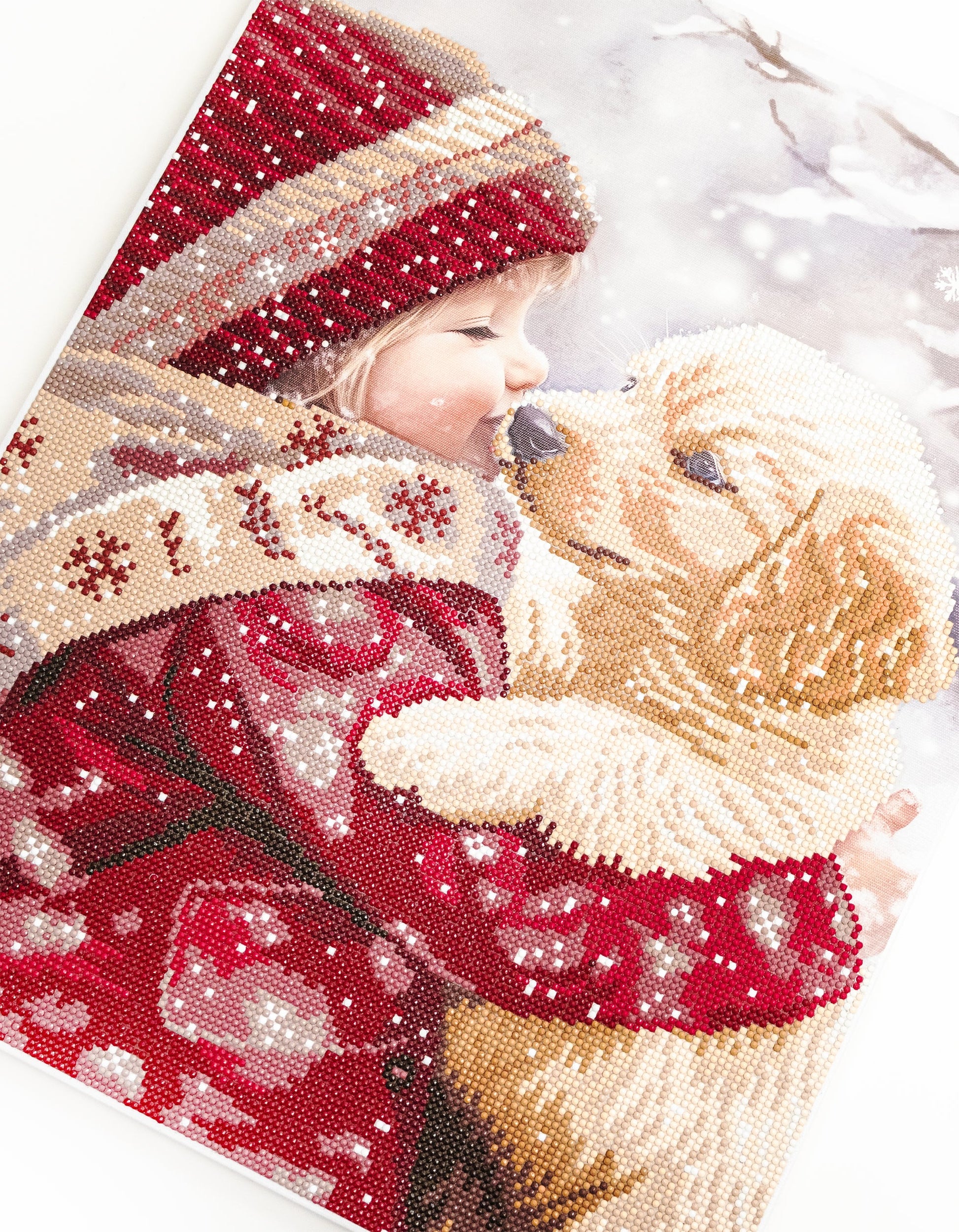 Crystal art design of a child and dog in winter clothing with snowflakes.