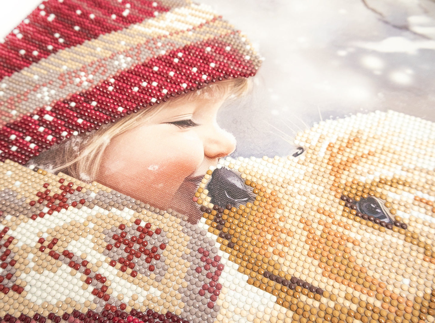 Close-up of a child wearing a beaded hat and coat with a soft focus background