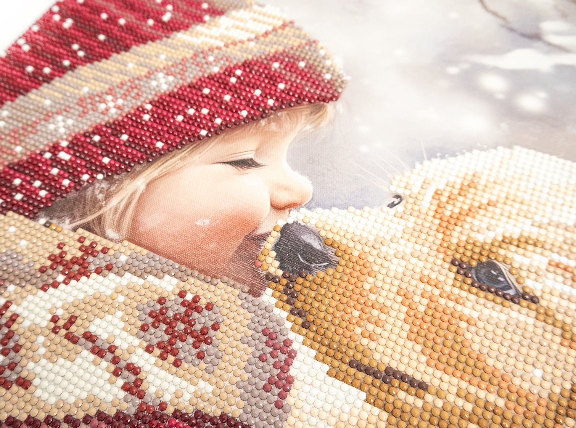 Close-up of a child wearing a beaded hat and coat with a soft focus background