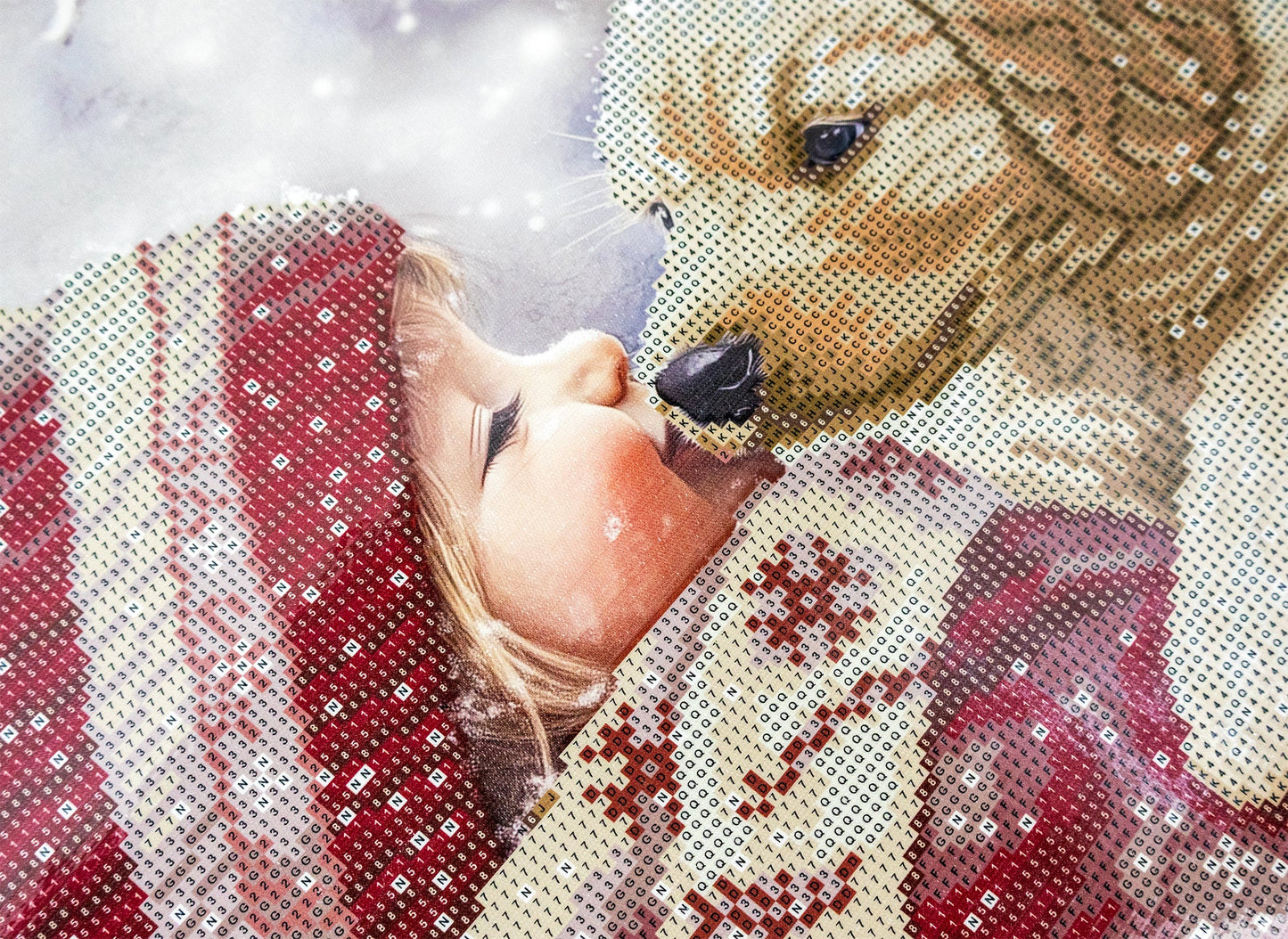 Diamond Art design of a puppy and a person wrapped in a blanket with snowflakes in the background
