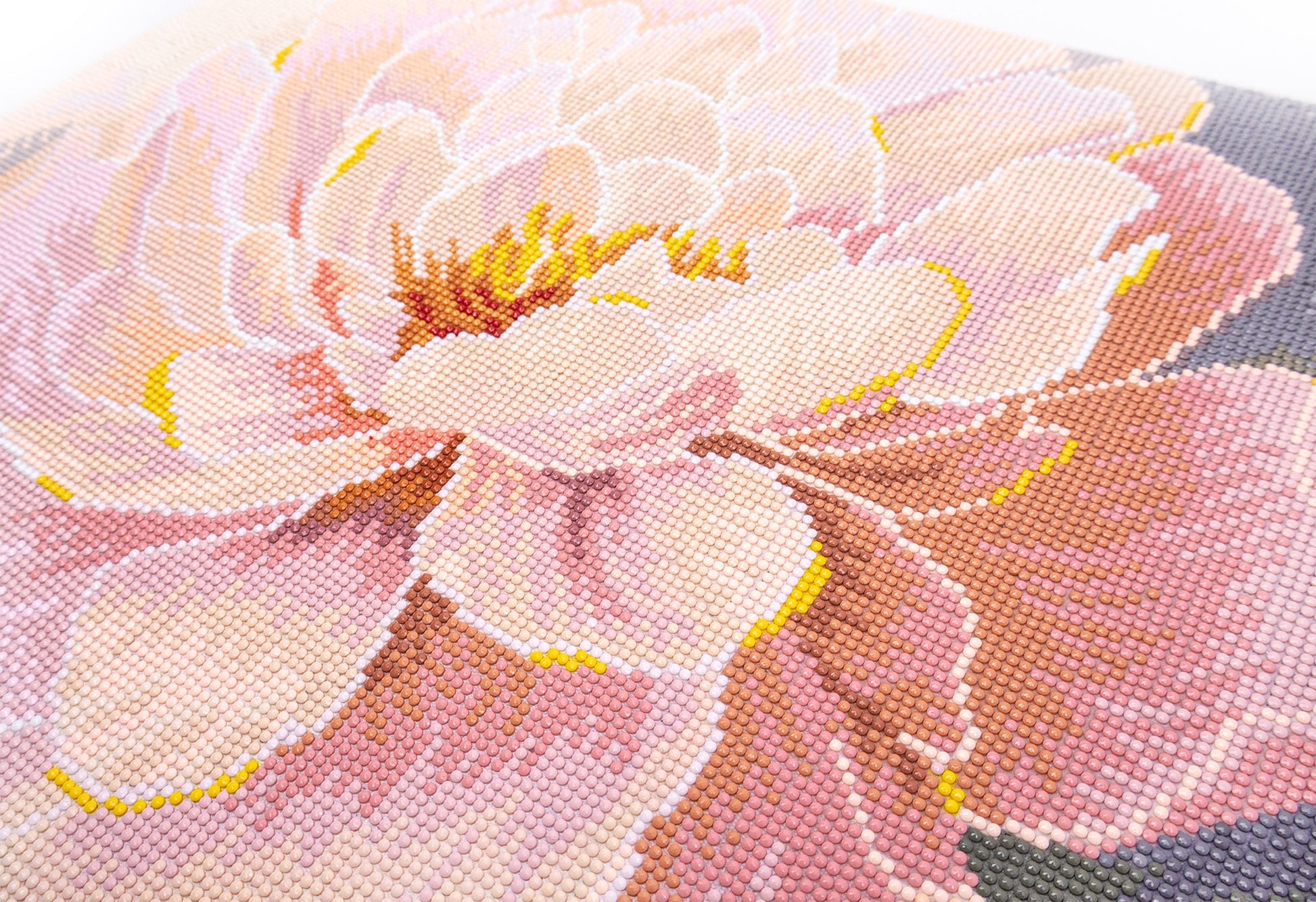 Close-up of a pink floral pattern on fabric crystal art, diamond painting