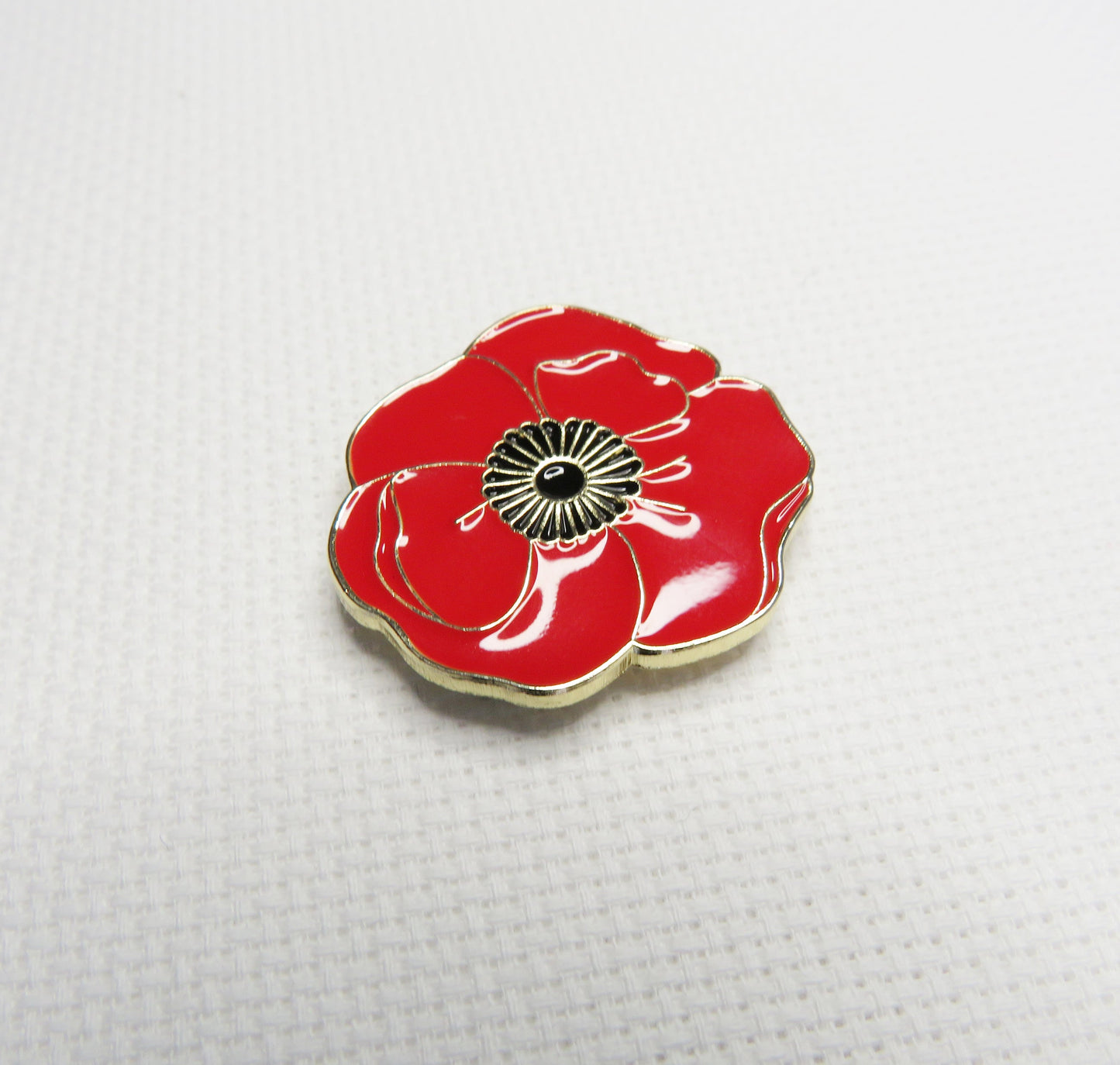 Red poppy flower needleminder on a white background