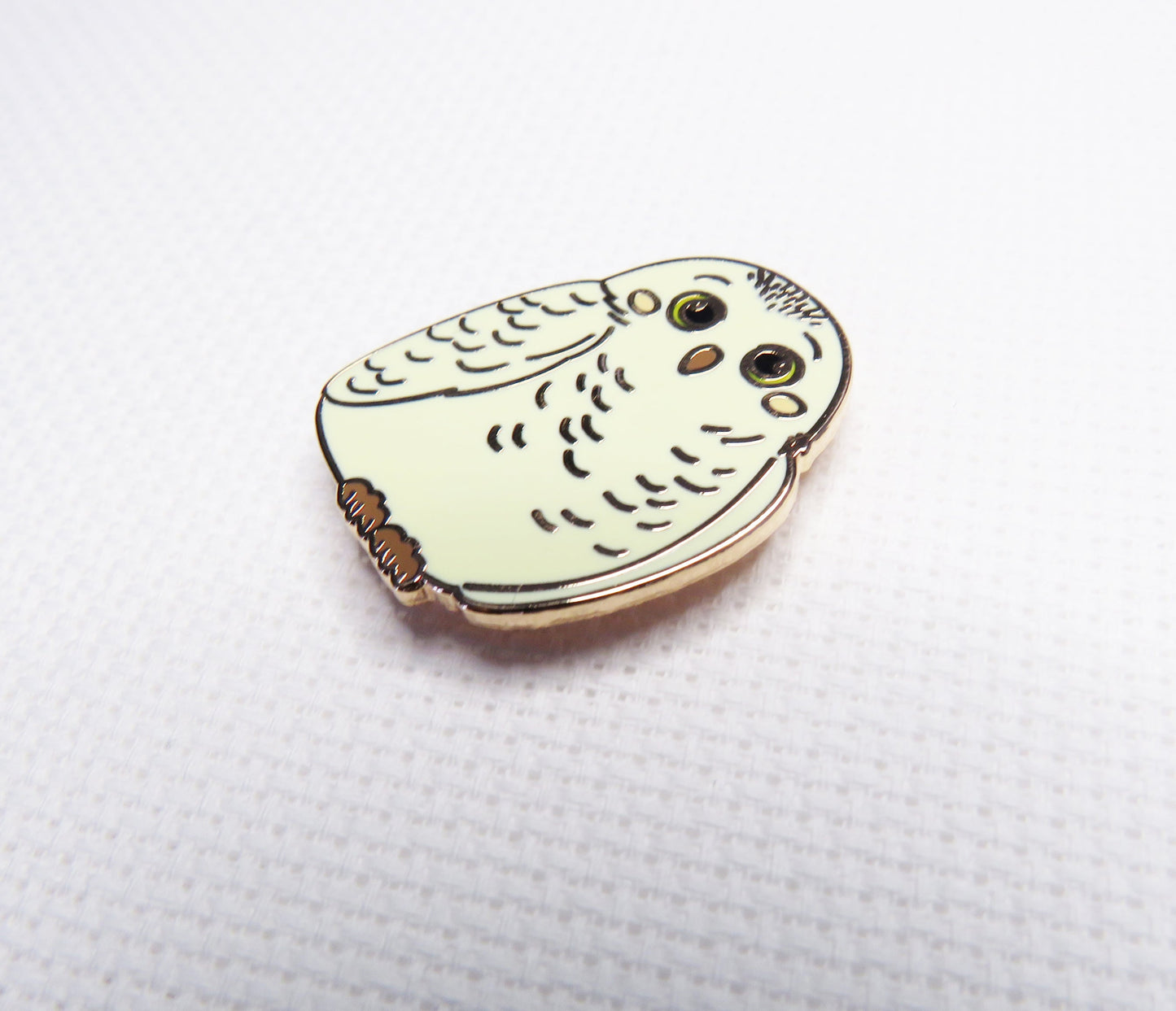 needleminder with owl design on a white background