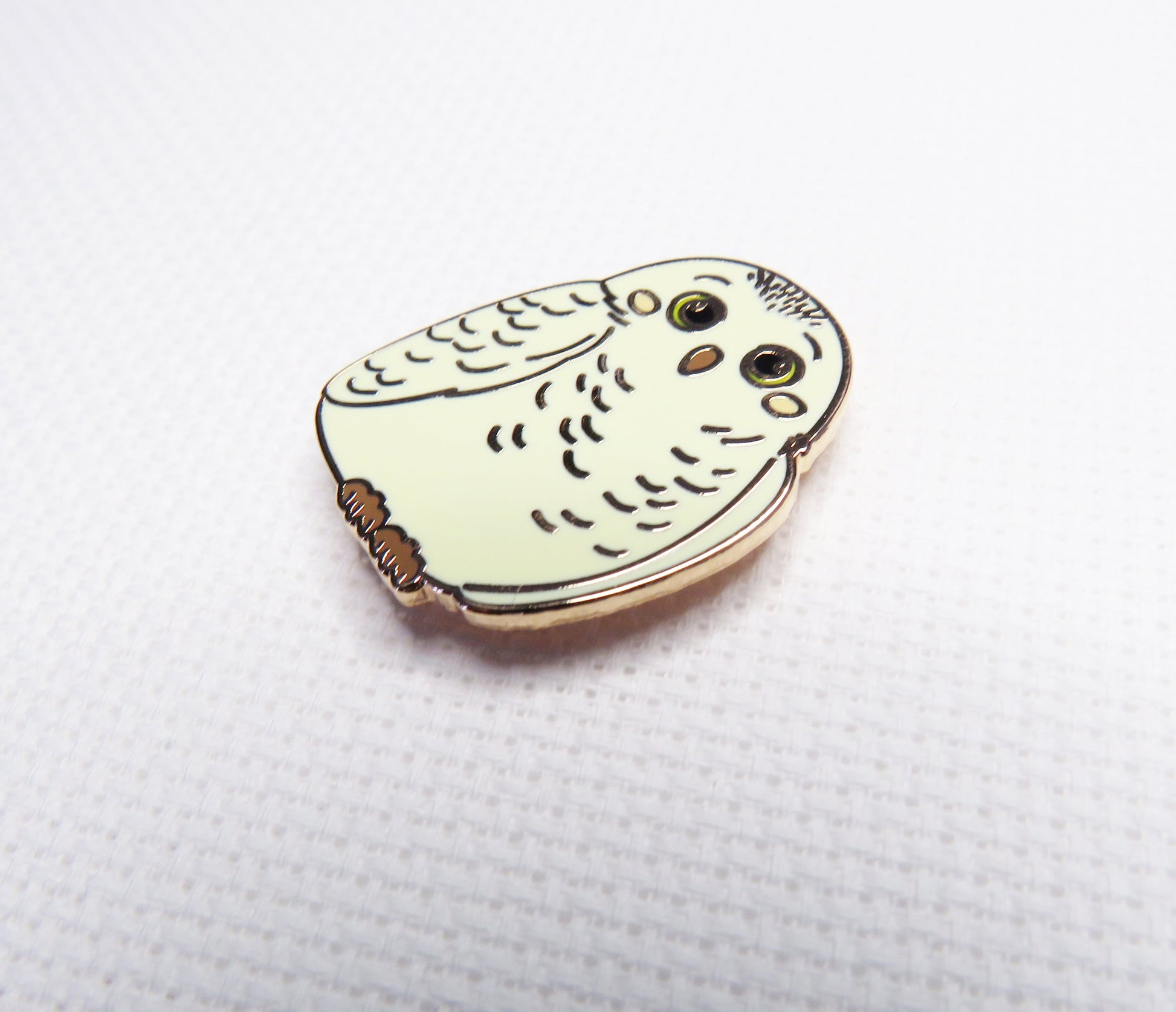 needleminder with owl design on a white background