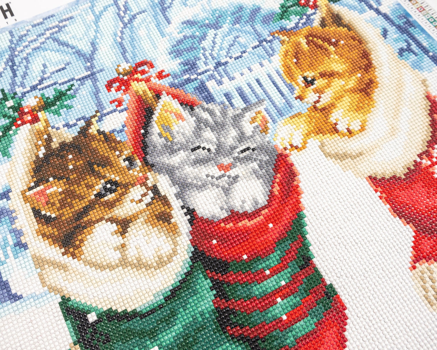 Christmas-themed crystal art picture with cats in festive outfits