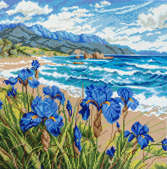 Diamond Art of blue flowers by a coastal landscape with mountains.