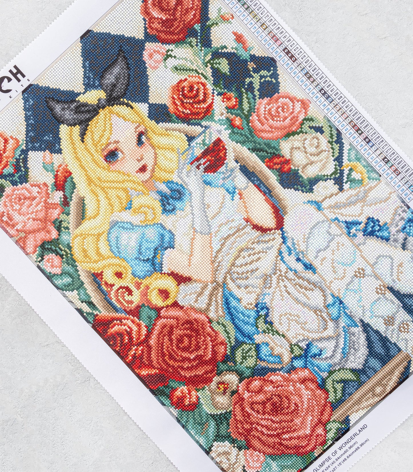 Diamond Art piece of art featuring a character with long blonde hair and blue dress, surrounded by flowers on a white background.