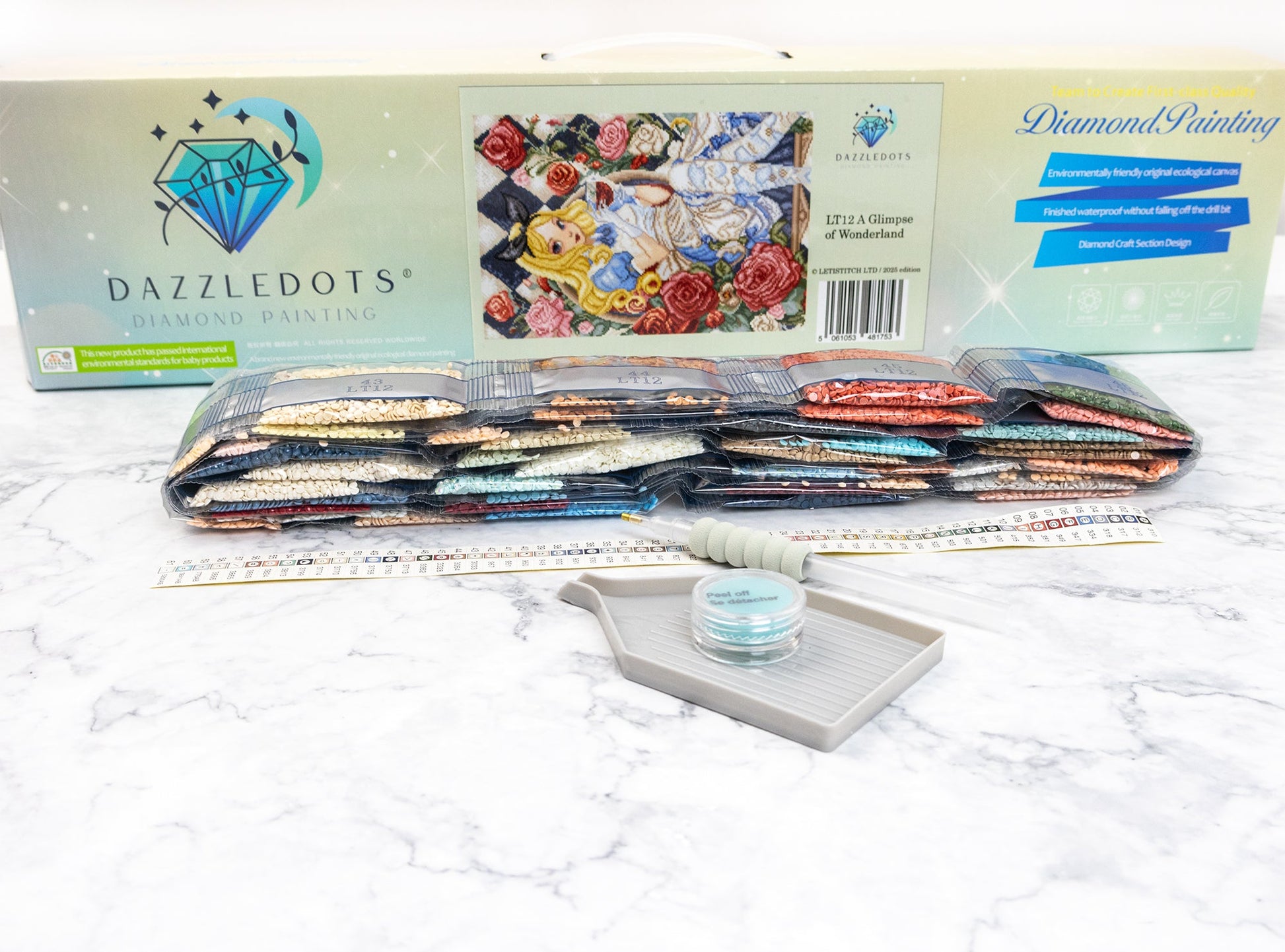 Dazzledots diamond painting kit with tools on a white surface